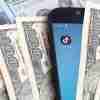 tiktok advertising cost - mobile showing tiktok logo surrounded by $100 bills