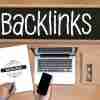backlinks word displayed on blackboard on desk with laptop and mobile phone